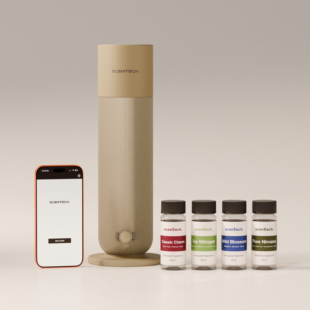The Scentech Smart Aroma Diffuser 2 beside the phone app and two sealed 65 ml fragrance pods